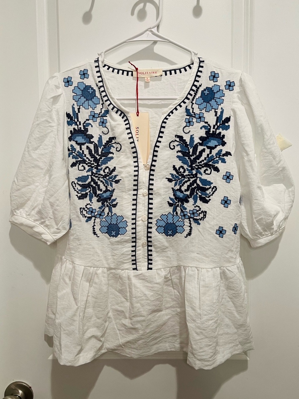 SOLITAIRE White Peplum Top with Blue Floral Embroidery